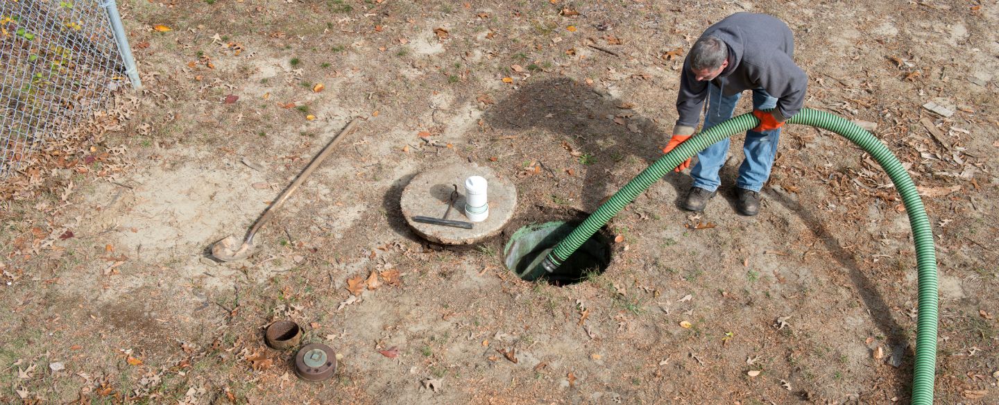 man cleans home septic tank using hose to pump sewage ovalo tx